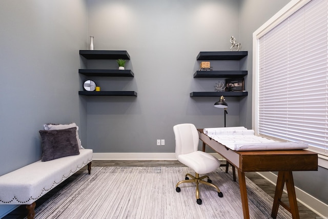 office space with wood finished floors and baseboards