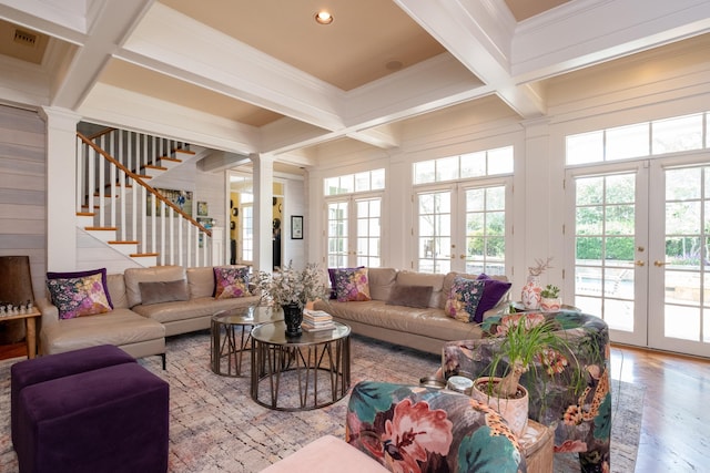 living room featuring coffered ceiling, decorative columns, stairs, french doors, and beamed ceiling