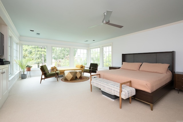 bedroom with light carpet, ceiling fan, and crown molding