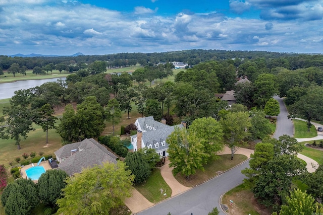 drone / aerial view featuring a view of trees and a water view