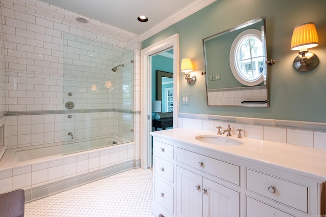 full bathroom featuring tile patterned floors, tiled shower / bath, vanity, and crown molding