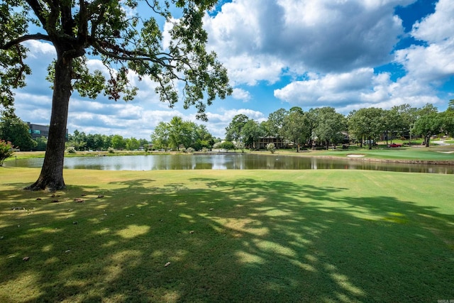 surrounding community with a yard and a water view