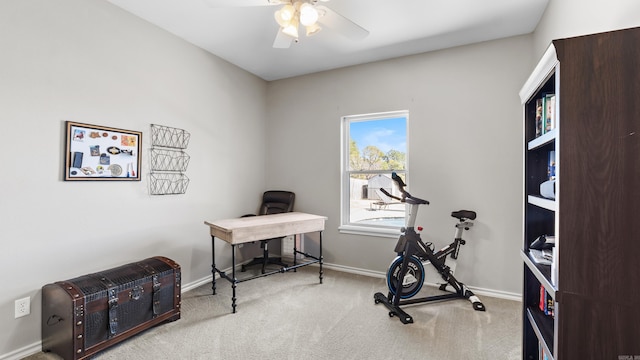 carpeted home office with baseboards and ceiling fan