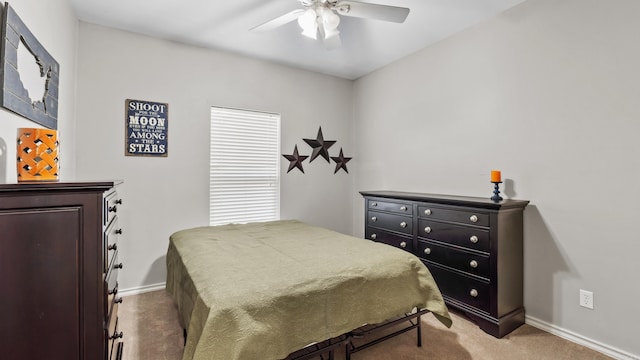 carpeted bedroom with baseboards and a ceiling fan