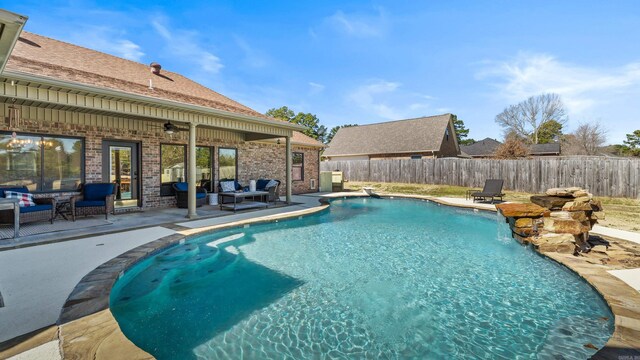 view of pool featuring a fenced in pool, an outdoor hangout area, a fenced backyard, a patio area, and a ceiling fan