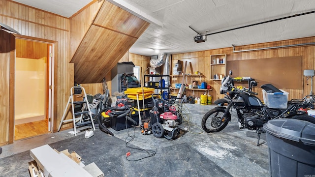 garage featuring wooden walls and a garage door opener