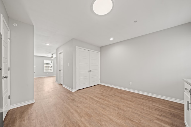 spare room with recessed lighting, baseboards, a ceiling fan, and light wood finished floors