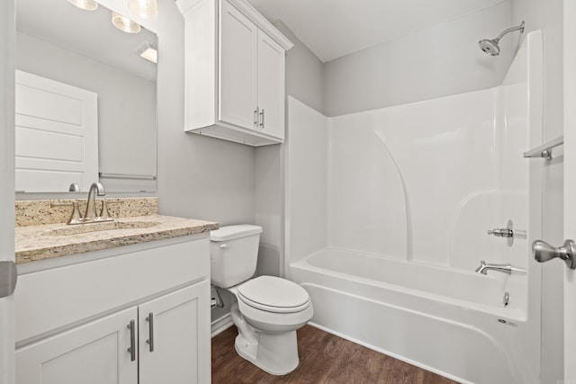 full bathroom with visible vents, toilet, wood finished floors, shower / bathing tub combination, and vanity