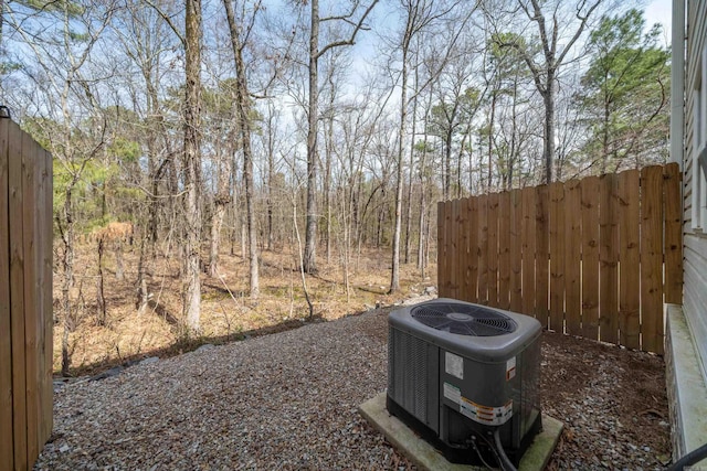 view of yard featuring central air condition unit and fence