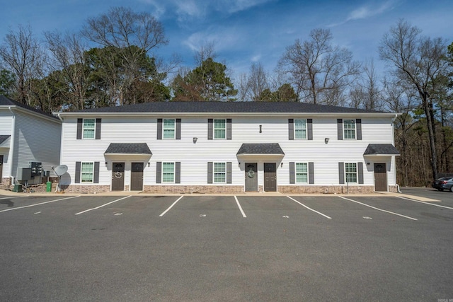 view of building exterior featuring uncovered parking