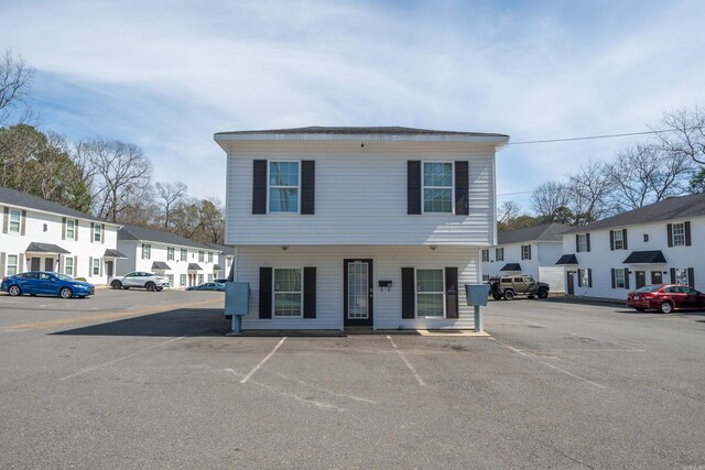 view of front of property featuring a residential view and uncovered parking