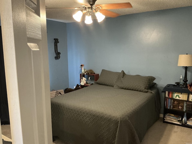 bedroom with carpet floors, a textured ceiling, and ceiling fan