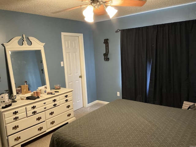 bedroom featuring ceiling fan, carpet floors, and a textured ceiling