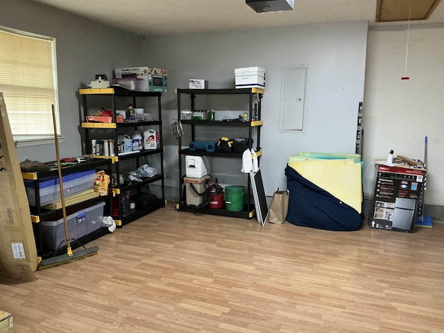 storage room featuring electric panel and attic access