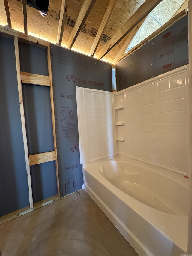 full bath with a bathtub and concrete floors