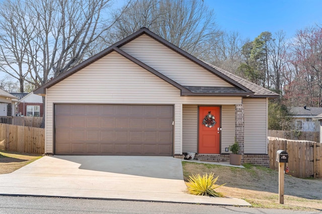 view of front facade featuring entry steps, a shingled roof, a garage, and fence