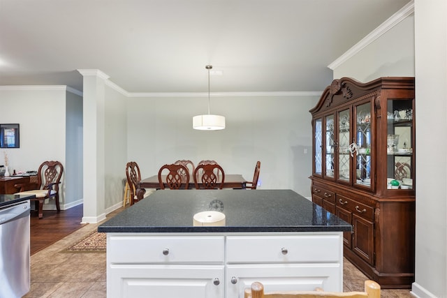 kitchen featuring baseboards, ornamental molding, white cabinets, dishwasher, and dark countertops