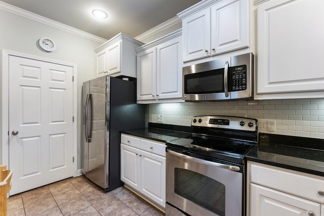 kitchen with backsplash, ornamental molding, appliances with stainless steel finishes, light tile patterned flooring, and white cabinetry