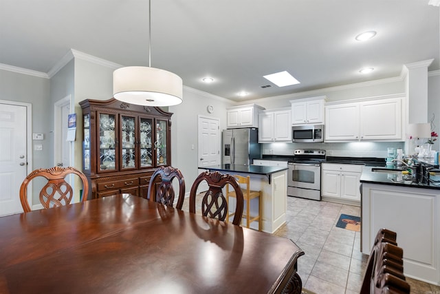 dining space featuring light tile patterned floors, recessed lighting, and crown molding