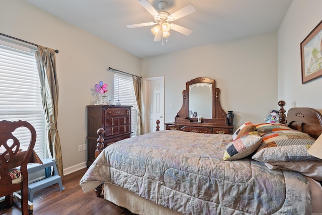 bedroom with a ceiling fan, wood finished floors, and baseboards