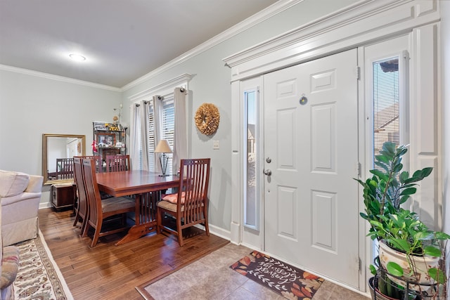 foyer featuring wood finished floors, baseboards, and ornamental molding