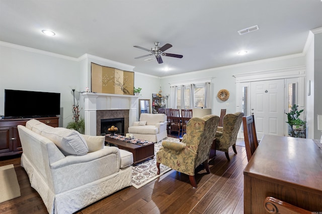 living room with visible vents, dark wood-type flooring, and crown molding