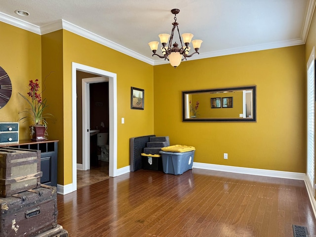 dining area with crown molding, baseboards, and wood finished floors