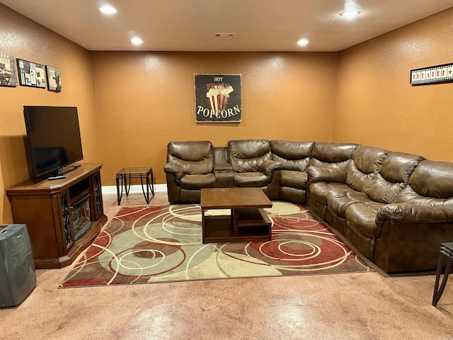 living area with visible vents, recessed lighting, carpet, baseboards, and a textured wall