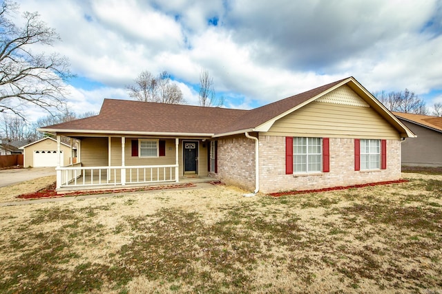 ranch-style home with brick siding, covered porch, a shingled roof, and a garage