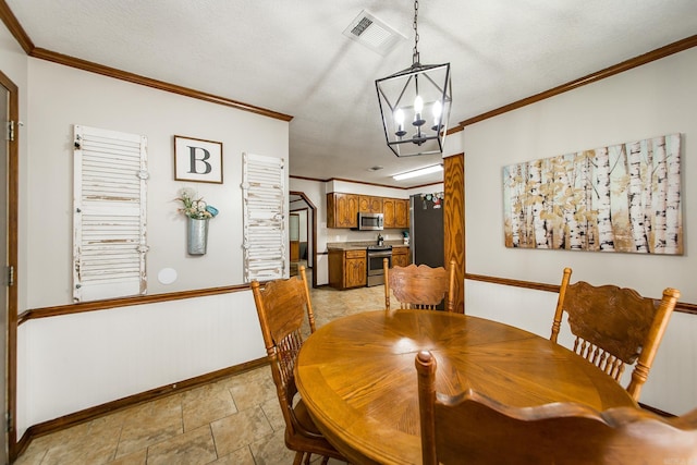 dining area with visible vents, a textured ceiling, crown molding, and an inviting chandelier