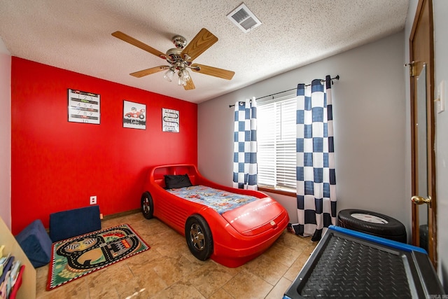 bedroom with visible vents, a textured ceiling, and ceiling fan