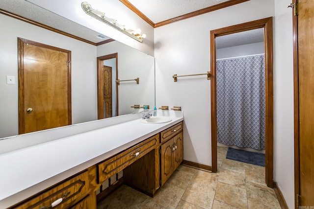 bathroom with visible vents, a textured ceiling, crown molding, baseboards, and vanity