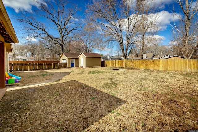 view of yard with a fenced backyard and an outdoor structure