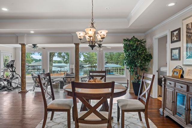 dining space featuring dark wood-style floors, ornate columns, recessed lighting, ornamental molding, and ceiling fan with notable chandelier