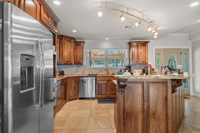 kitchen with visible vents, ornamental molding, light stone counters, tasteful backsplash, and stainless steel appliances