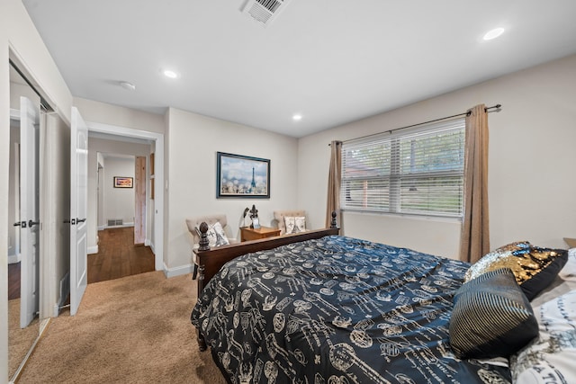 carpeted bedroom featuring visible vents, recessed lighting, and baseboards