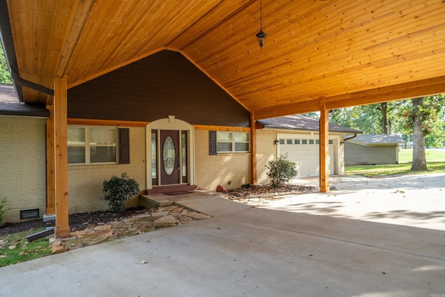 exterior space featuring a garage, brick siding, and concrete driveway