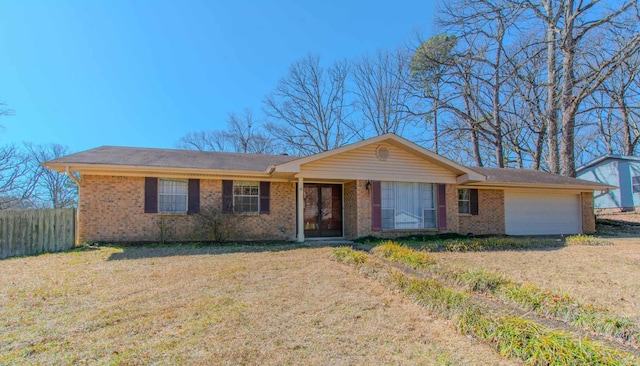 single story home with brick siding, an attached garage, a front yard, and fence