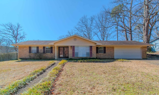 ranch-style house with brick siding, a front yard, and a garage