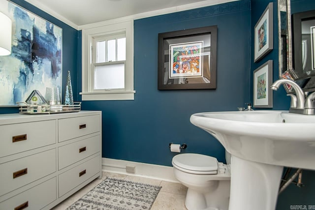 bathroom with tile patterned flooring, toilet, and baseboards