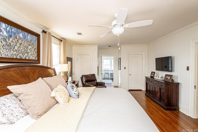 bedroom with dark wood-style floors, visible vents, multiple windows, and ornamental molding