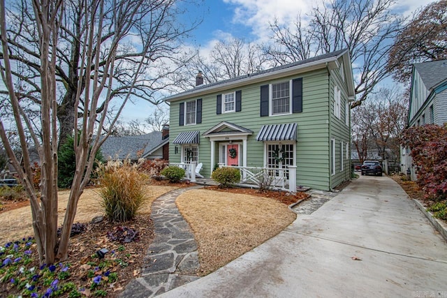 view of front of property with driveway and a chimney