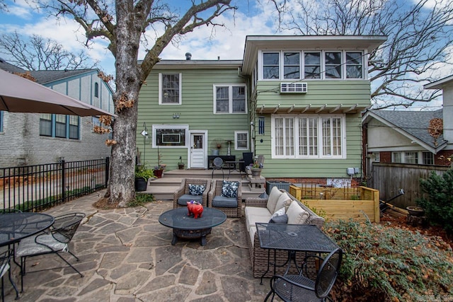 rear view of house featuring a patio area, an outdoor hangout area, a deck, and fence