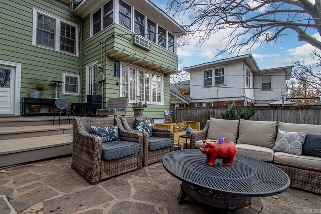 view of patio featuring outdoor lounge area and fence