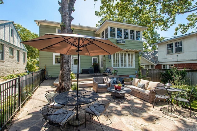 view of patio featuring outdoor lounge area, outdoor dining area, and a fenced backyard