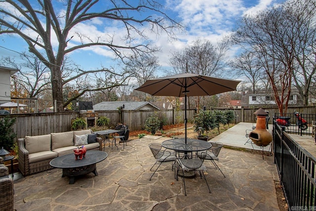 view of patio featuring an outdoor living space, outdoor dining area, and a fenced backyard