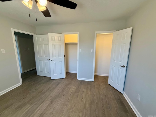 unfurnished bedroom with baseboards, ceiling fan, and dark wood-style flooring