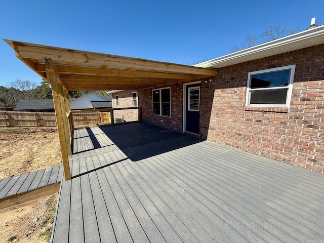 wooden terrace featuring fence