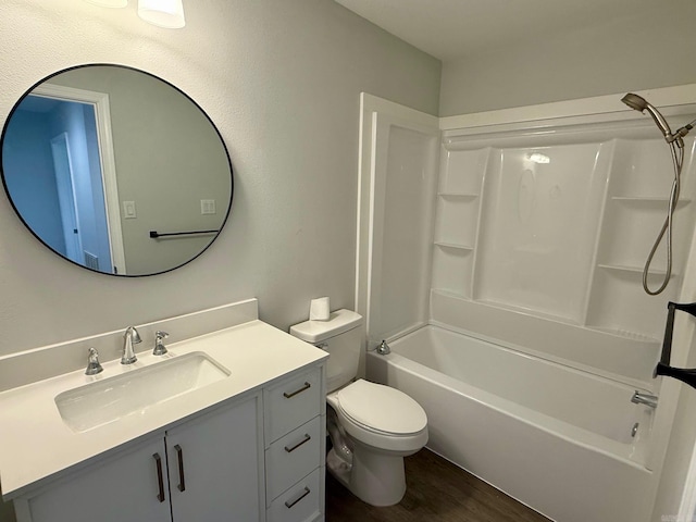 full bathroom featuring vanity, toilet, wood finished floors, and shower / bath combination