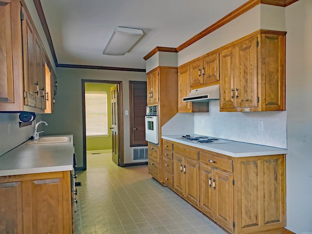 kitchen featuring range hood, a sink, ornamental molding, electric cooktop, and white oven